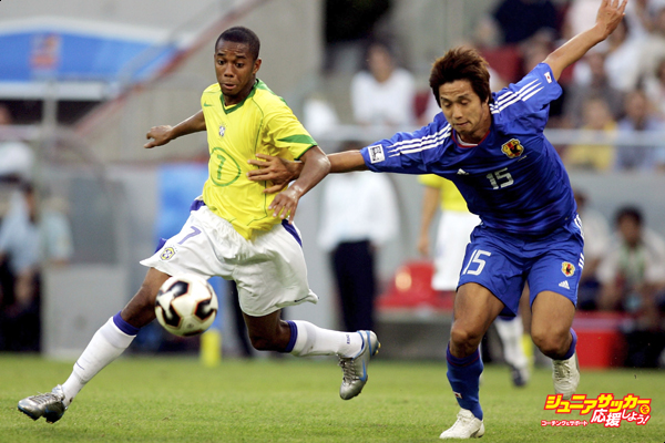 COLOGNE, GERMANY - JUNE 22: Robinho from Brazil in action with Takashi Fukunishi from Japan during the match between Japan and Brazil for the Confederations Cup 2005  at the RheinEnergie Stadium on June 22, 2005 in Cologne, Germany.  (Photo by Lars Baron/Bongarts/Getty Images)