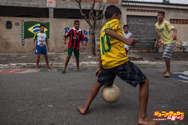 PRAIA GRANDE, BRAZIL - JUNE 17:  Boys play soccer in the streets of the Garden Gloria neighborhood on June 17, 2014 in Praia Grande, Brazil.  Soccer star Neymar of Brazil lived in this neighborhood between 7 and 12 years of age and is building a sports and educational center for the neighborhood kids. (Photo by Victor Moriyama/Getty Images)