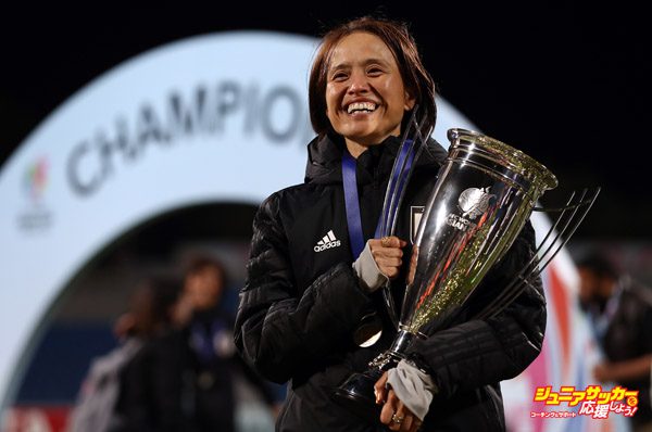 AMMAN, JORDAN - APRIL 20: Head coach of Japan, Asako Takemoto poses with the trophy after winning the AFC Women's Asian Cup final between Japan and Australia at the Amman International Stadium on April 20, 2018 in Amman, Jordan.  (Photo by Francois Nel/Getty Images)