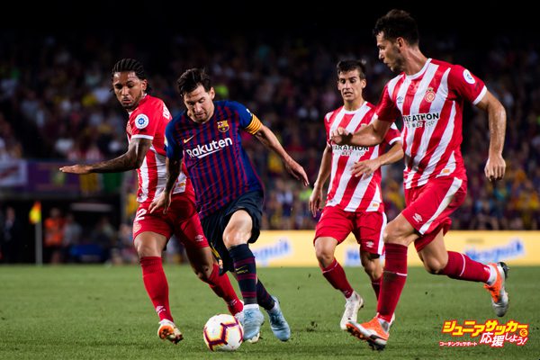 BARCELONA, SPAIN - SEPTEMBER 23:  Lionel Messi of FC Barcelona conducts the ball under pressure from Douglas Luiz (L) and Pedro Alcala (R) of Girona FC during the La Liga match between FC Barcelona and Girona FC at Camp Nou on September 23, 2018 in Barcelona, Spain.  (Photo by Alex Caparros/Getty Images)