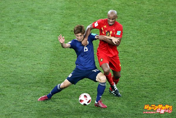 ROSTOV-ON-DON, RUSSIA - JULY 02:  Yuya Osako of Japan is challenged by Vincent Kompany of Belgium during the 2018 FIFA World Cup Russia Round of 16 match between Belgium and Japan at Rostov Arena on July 2, 2018 in Rostov-on-Don, Russia.  (Photo by Robert Cianflone - FIFA/FIFA via Getty Images)